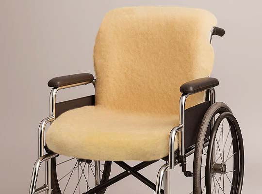 Medical-grade sheepskin rug placed in a wheelchair for natural support and patient comfort